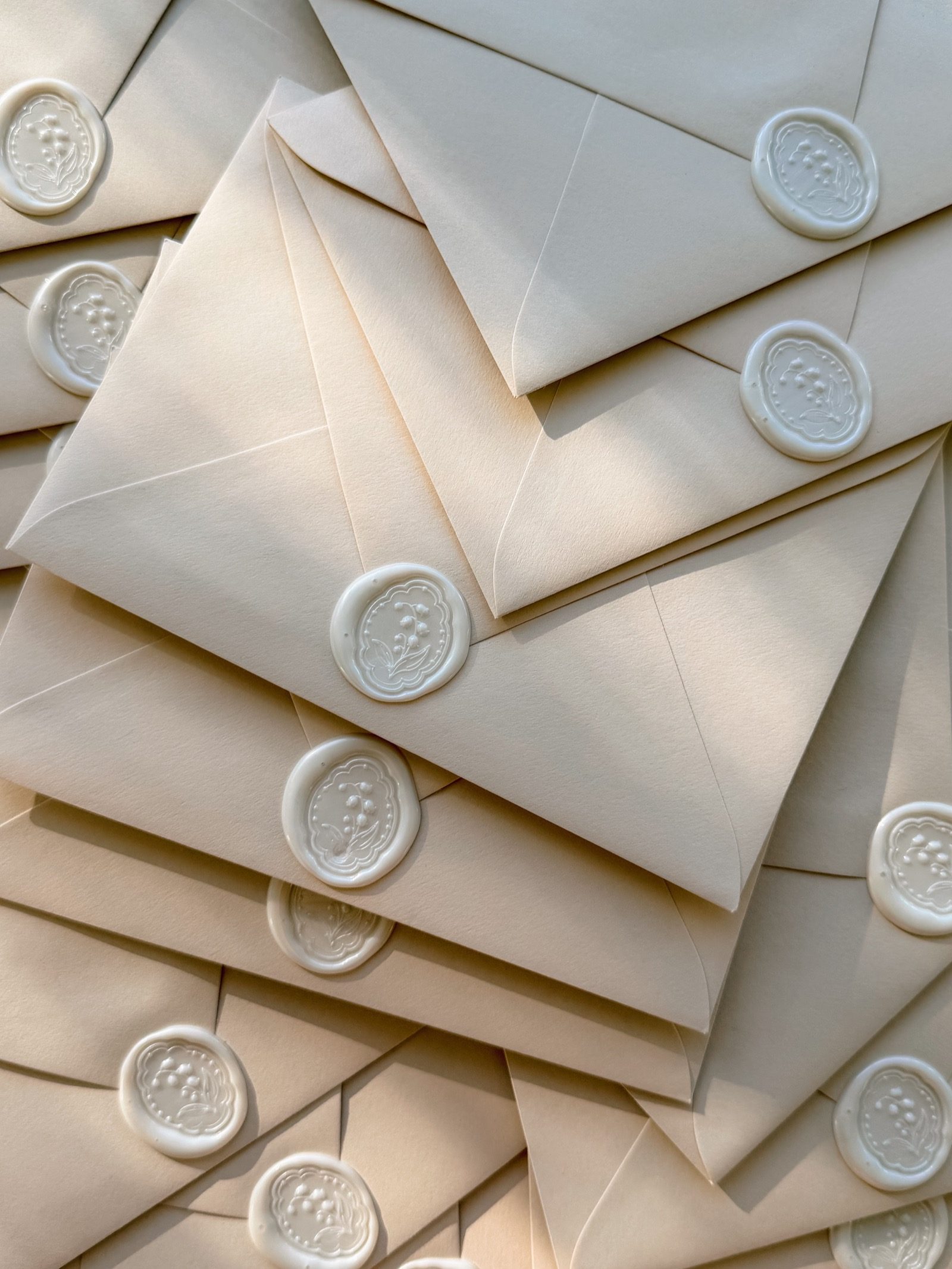 Cream envelopes finished with floral wax seals
